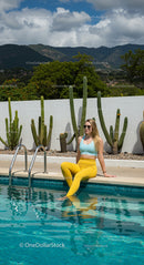 Woman Relaxing by Poolside with Cactus and Mountain View