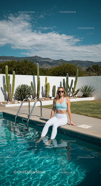 Woman Relaxing by Poolside with Cacti and Mountain Views