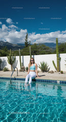 Woman Relaxing by Pool in a Desert Garden