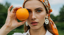 Fashionable Woman Holding Orange in the Park