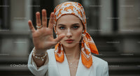 Fashionable Woman with Orange Headscarf in Urban Setting