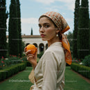 Elegant Woman with an Orange in Mediterranean Garden