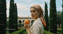 Woman Holding Orange in Mediterranean Garden