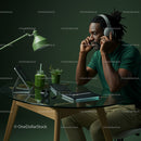 Focused Man Working with Headphones in Green Home Office