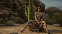 Elegant Woman in Paisley Dress Amidst Desert Rocks