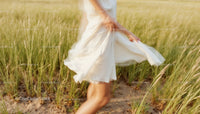 Carefree Woman Dancing in a Summer Field