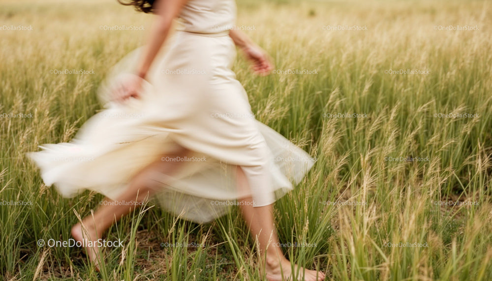 Woman Running in a Field of Tall Grass