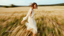 Woman Running Freely Through Golden Wheat Field
