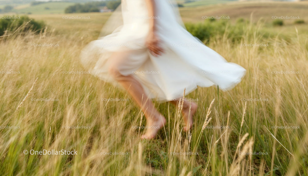 Woman Dancing Freely in a Sunlit Summer Meadow
