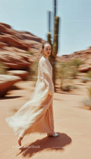 Elegant Woman in Flowing Dress in Desert Landscape