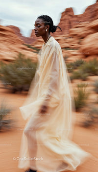 Elegant Woman in Flowing Dress Among Sandstone Formations