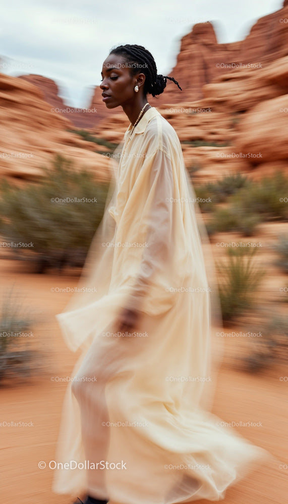 Elegant Woman in Flowing Dress Among Sandstone Formations