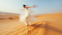Blurred Woman Dancing Across Desert Dunes