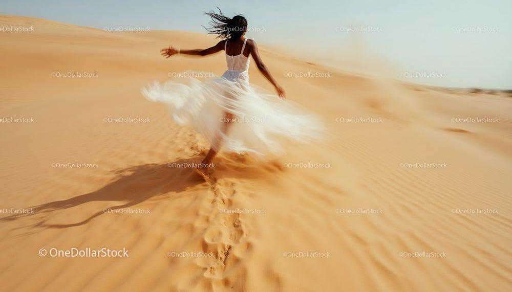 Woman in White Dress Running Across Desert Dunes