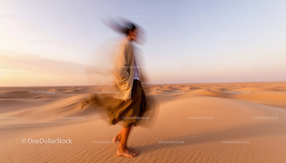 Person Walking Through Ethereal Desert Landscape at Sunset