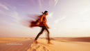 Woman Running Across Sunset Desert Sand Dunes