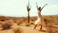 Graceful Dance in Desert with Flowing Dress and Cactus