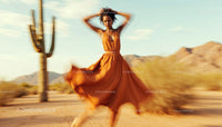 Woman Dancing in Flowing Dress in Desert Landscape