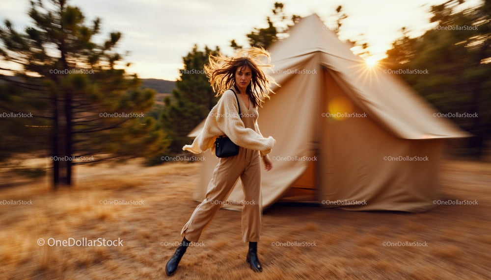 Woman in Cozy Sweater Moving Near Tent at Sunset