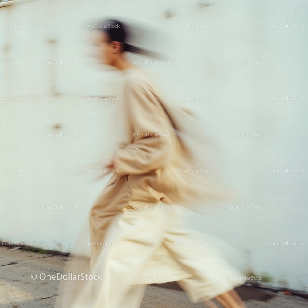 Blurred Figure in Stylish Beige Urban Attire