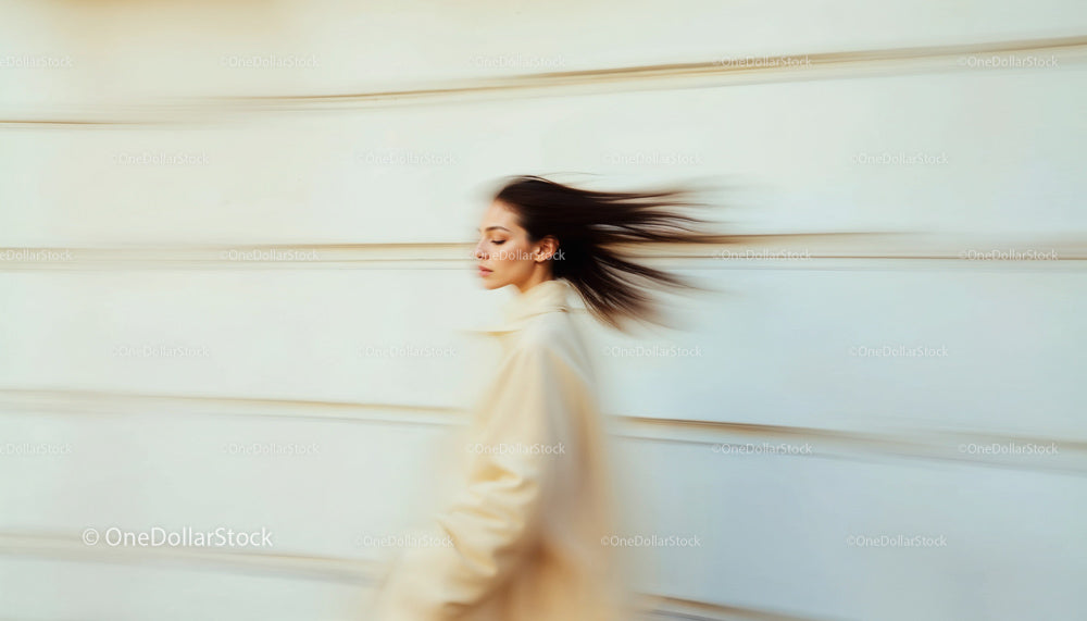 Elegant Woman in Motion Blur Walking in Stylish Beige Coat