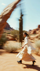 Woman Running Freely in a Vast Desert Landscape