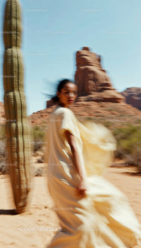 Woman in Flowing Dress Amidst Desert Scenery