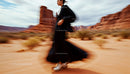 Elegant Woman in Motion in Stunning Desert Landscape