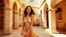 Woman in Flowing Dress in Sunlit Courtyard