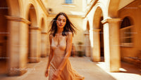 Woman in Flowing Dress in Sunlit Courtyard