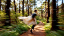 Woman in Flowing Dress Running Through Forest Path