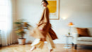 Elegant Woman in Motion in Minimalist Beige Living Room