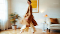 Elegant Woman in Motion in Minimalist Beige Living Room