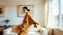 Elegant Woman in Motion in a Modern Living Room
