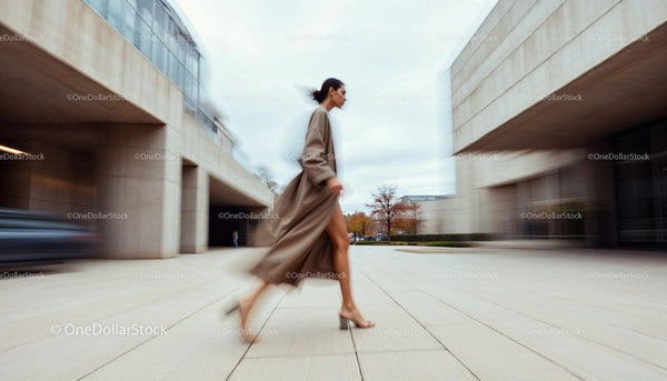 Woman in Motion Against Modern Urban Backdrop