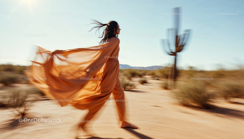 Woman in Flowing Dress Walking Through Desert Landscape