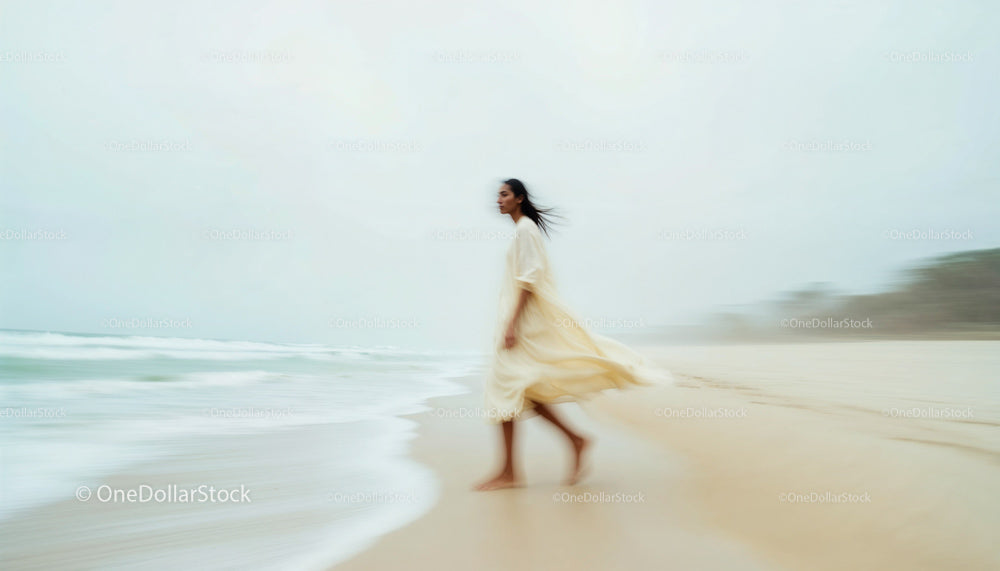 Woman Strolling on a Serene Beach with Gentle Waves