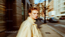 Stylish Woman Walking Through City Streets in Motion