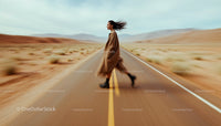 Woman Walking on Desert Highway in Motion Blur