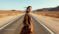 Woman in Brown Coat on Empty Desert Road