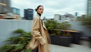 Stylish Woman in Beige Trench Coat on Rooftop Terrace