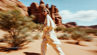 Woman in Stylish Beige Coat Moving Through Desert Canyon
