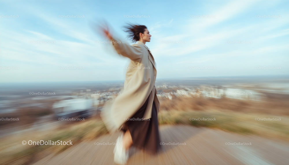 Woman Twirling with Elegance in Urban Landscape