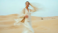 Mystical Woman in Beige Amidst Sand Dunes