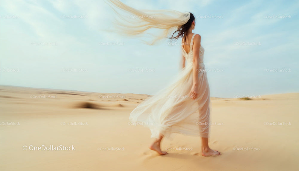 Elegant Woman Walking Through Serene Desert Landscape