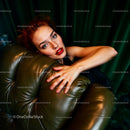Elegant Woman in Glamorous Pose on Leather Couch