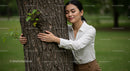 Mindful Woman Embracing a Tree in a Green Park