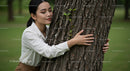 Woman Embracing Tree in a Tranquil Green Park
