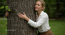 Woman Embracing Tree in a Green Park Setting