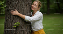 Woman Embracing Tree in Green Park for Mindful Connection